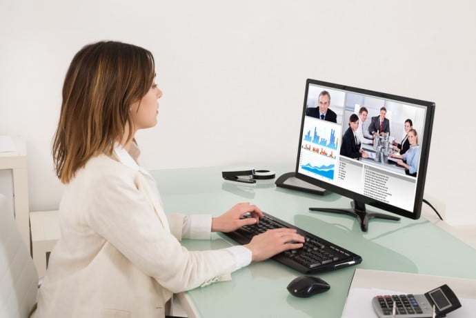 Young Businesswoman Video Conferencing On Computer In Office